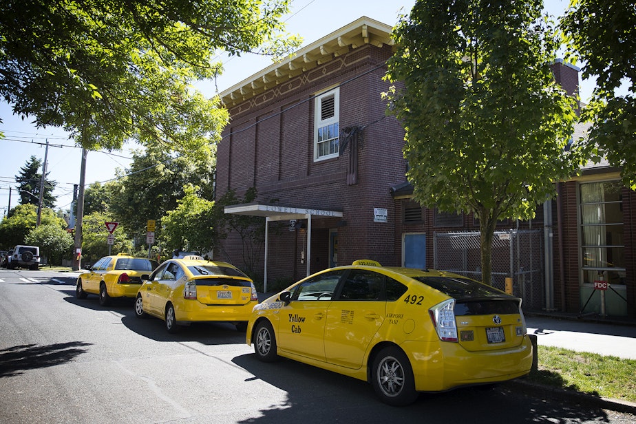 caption: Taxis line up outside of Lowell Elementary on Friday to pick up students. The district is required to provide transportation for homeless students. That may mean taxis take them to and from shelters.