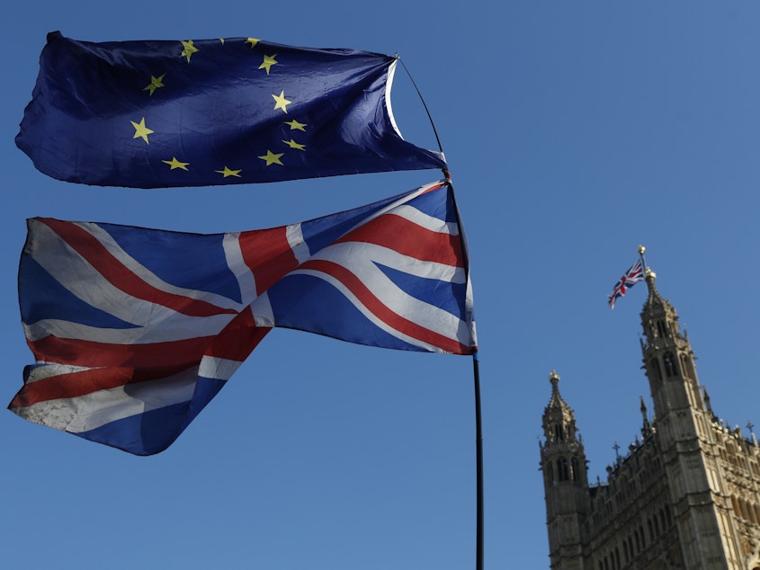 caption: Flags of the European Union and Great Britain are flown during a demonstration in London on Feb. 27. A key vote is to take place in Parliament on Tuesday.