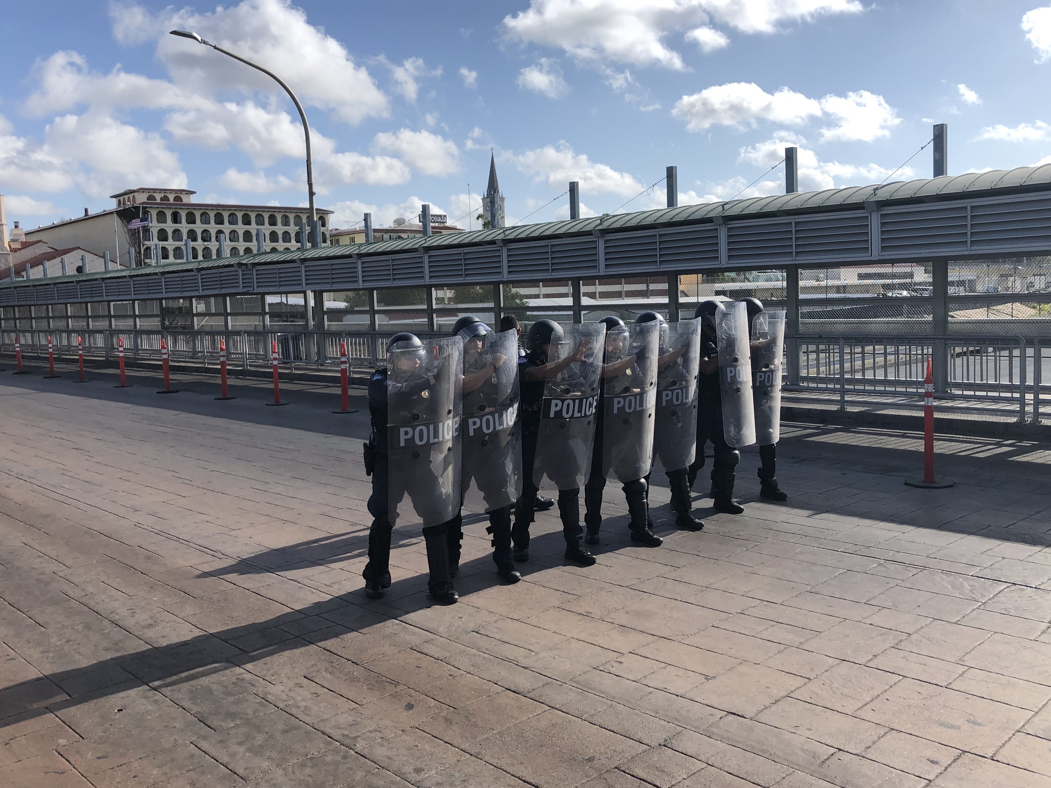 caption: A special response team with Customs and Border Protection drills on the international bridge between Laredo, Texas, and Nuevo Laredo, Mexico, in the event that desperate migrants rush the port of entry.