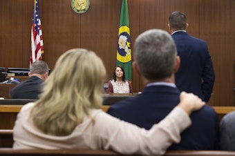 caption: Laura Baanstra, center, testifies at the trial of William Earl Talbott II on Friday, June 14. Talbott has been charged with killing her brother, Jay Cook, and his girlfriend Tanya van Cuylenborg in November of 1987. In the foreground: May Robson, left, Tanya's best friend, and John van Cuylenborg, Tanya's older brother, watch Baanstra's testimony.