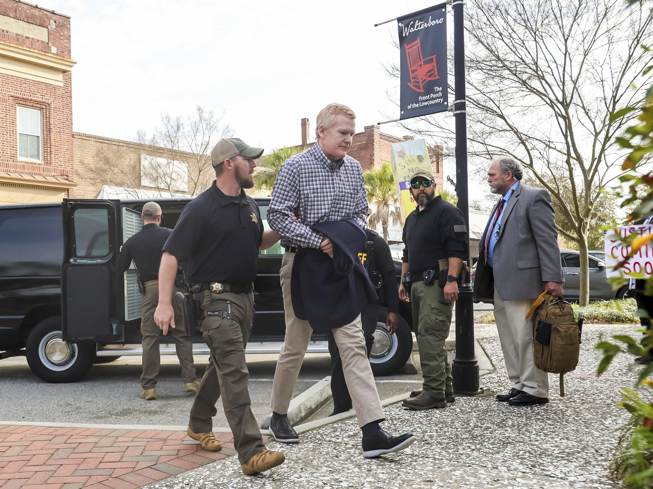 caption: Alex Murdaugh could face life in prison if he's convicted for the double murders of his wife and son. He's seen here being escorted into the the Colleton County Courthouse in Walterboro, S.C., on Monday.