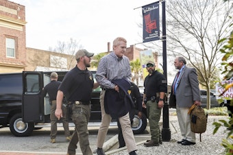 caption: Alex Murdaugh could face life in prison if he's convicted for the double murders of his wife and son. He's seen here being escorted into the the Colleton County Courthouse in Walterboro, S.C., on Monday.