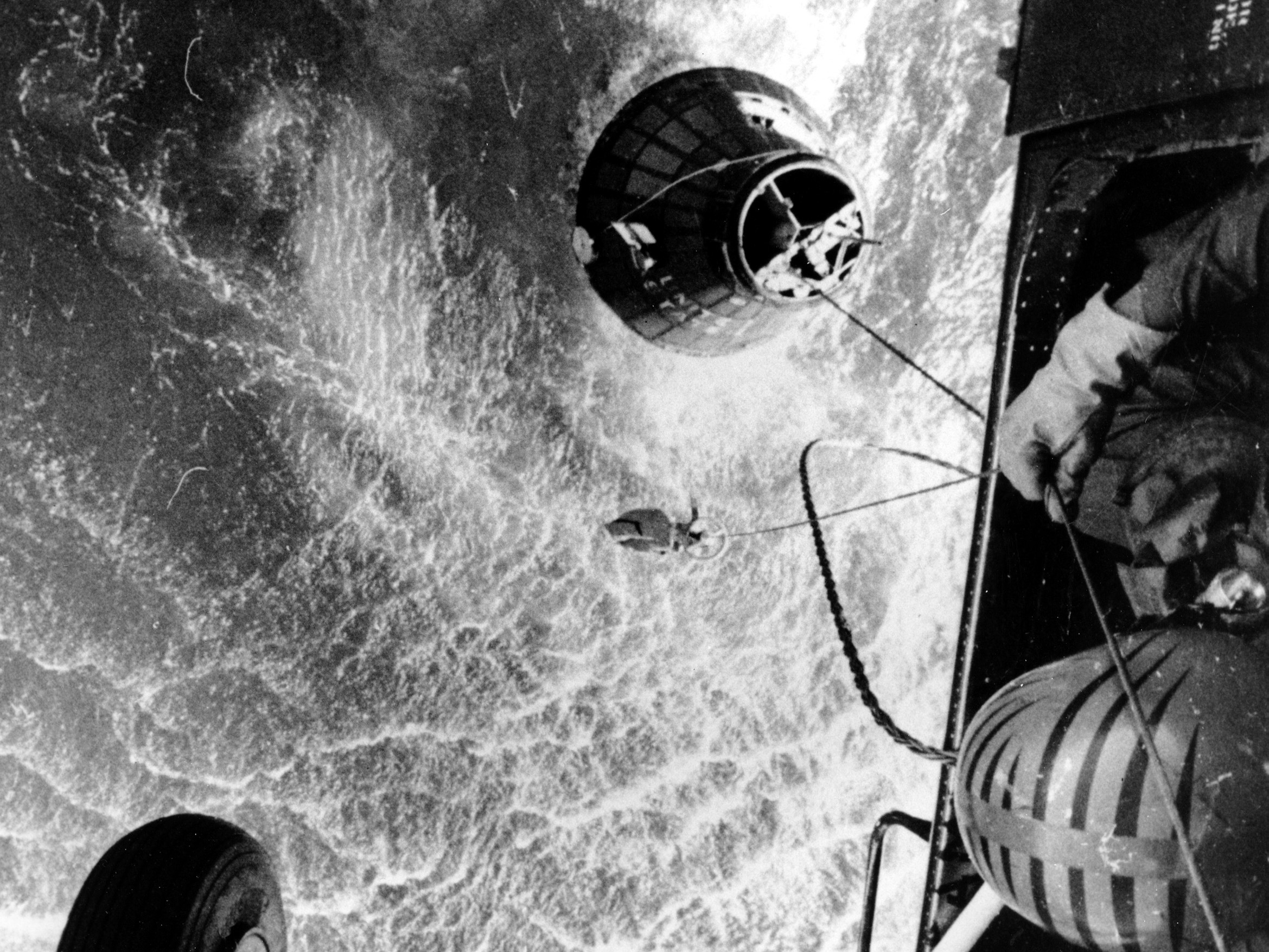 caption: A U.S. Marines helicopter hovers over the Atlantic ocean during an attempt to retrieve astronaut Gus Grissom's Liberty Bell 7, which sank 15,000 feet shortly after splashdown on July 21, 1961.