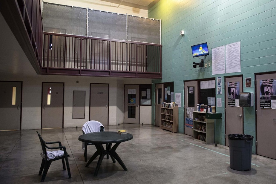 caption: A two-story common room contains doors to several detention rooms.
