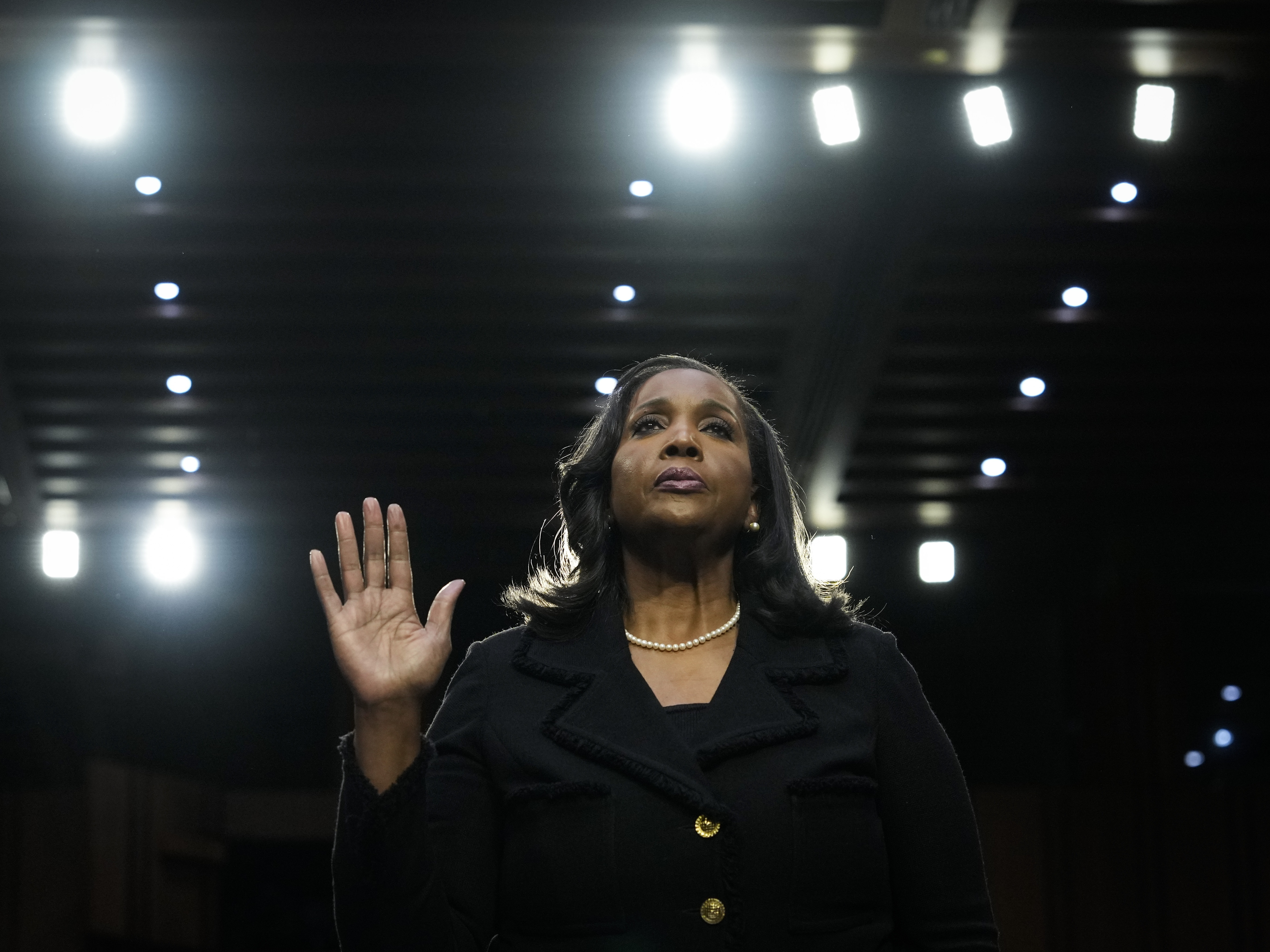 caption: Federal Reserve Governor Lisa Cook, the first Black woman to sit on the Board of Governors, has filed a lawsuit challenging President Trump's order to remove her.