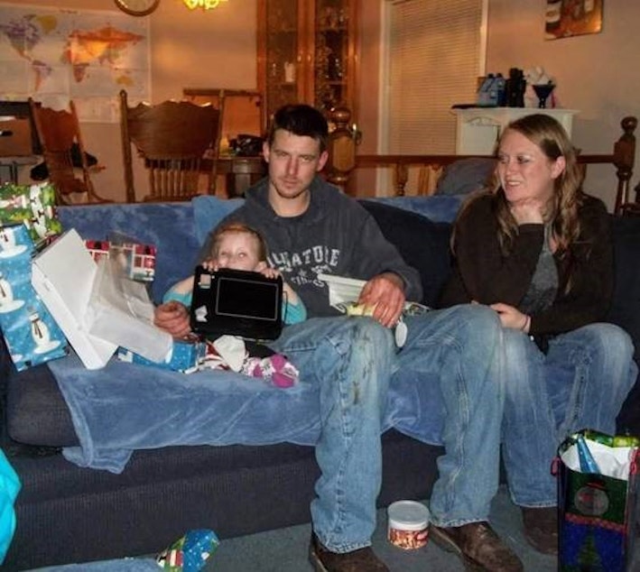 caption: Jeremy Lavender, Amy DeHart and their daughter at DeHart’s parents’ home on Christmas, 2011. 