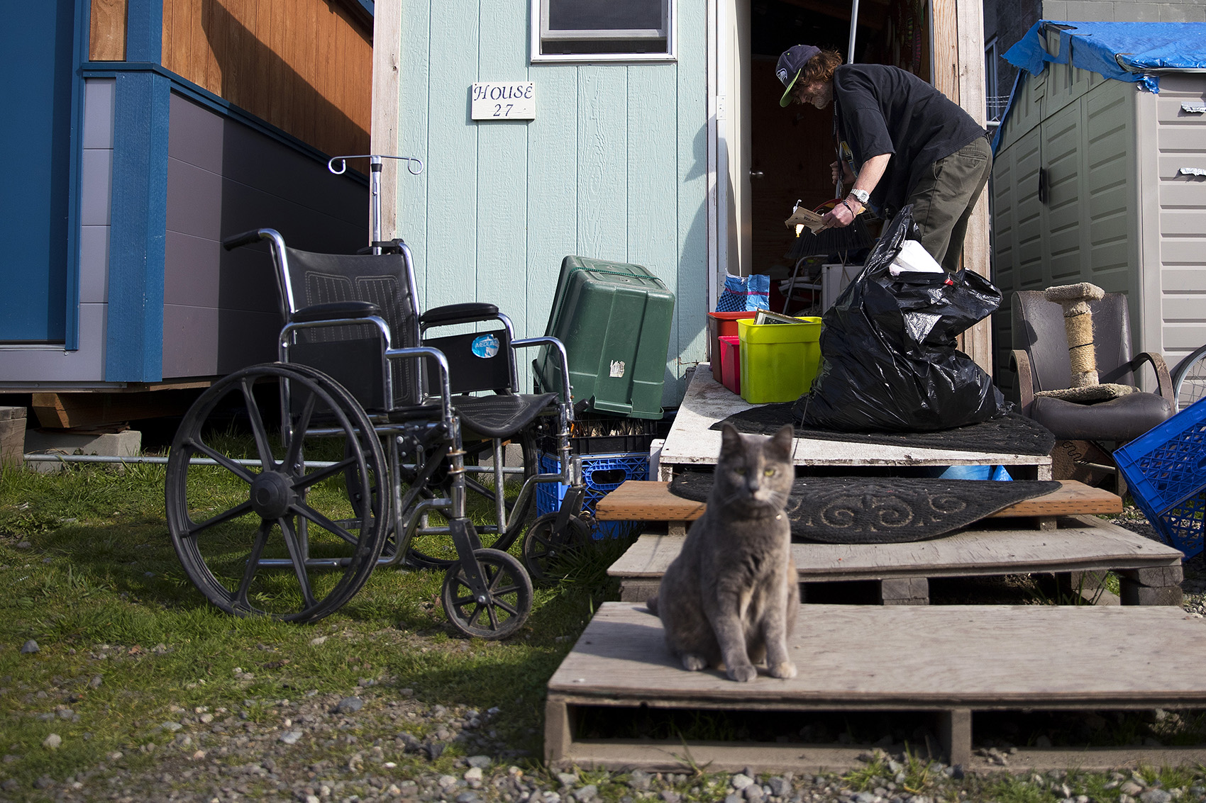 caption: Mike Tarp, 58, cleans his tiny home on Wednesday, March 21, 2018, in preparation for his significant other to return from the hospital, at the Licton Springs Tiny House Village in Seattle. 