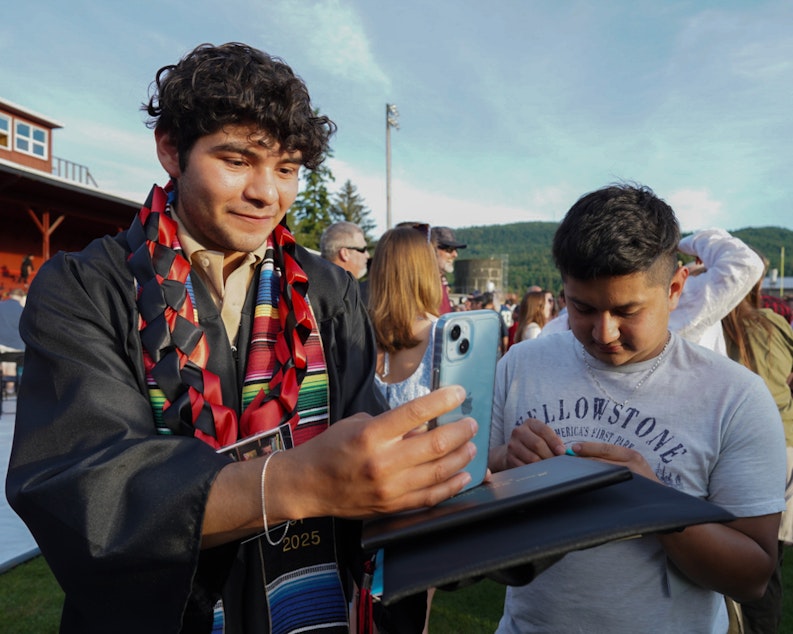 caption: Alex Guerrero Villatoro and his brother often work different hours. Here they're together in post-graduation celebrations before they head home Thursday, June 5.