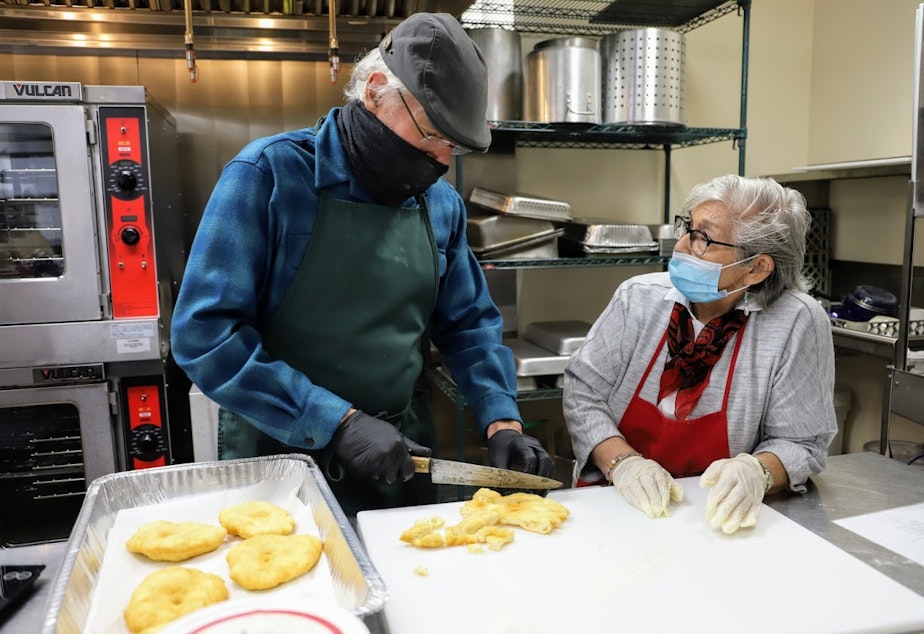 caption: David Lee, founder of the non-profit FoodCircle, cuts strips of frybread. Lee's Thanksgiving menu blends traditional dishes with Indigenous ingredients.