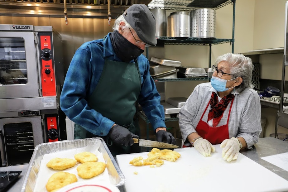 caption: David Lee, founder of the non-profit FoodCircle, cuts strips of frybread. Lee's Thanksgiving menu blends traditional dishes with Indigenous ingredients.