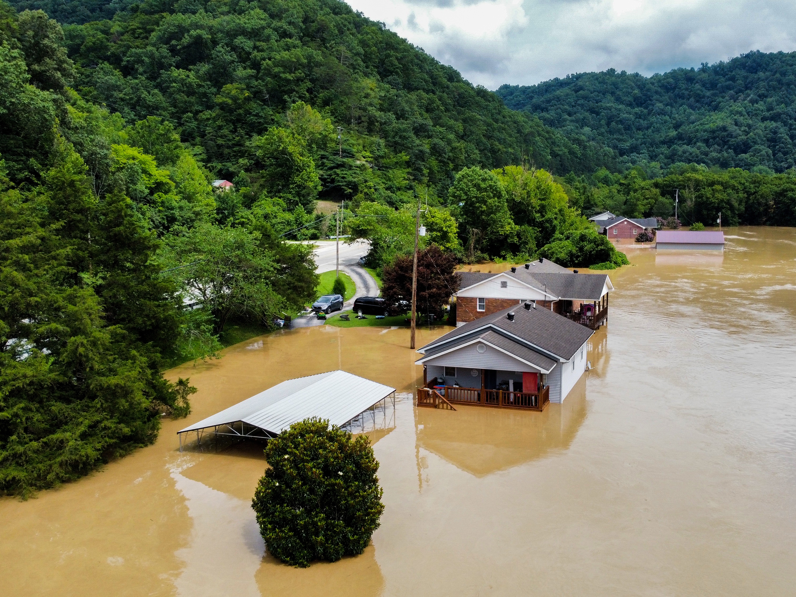 caption: Catastrophic flash floods killed dozens of people in eastern Kentucky in July 2022. Here, homes in Jackson, Ky., are flooded with water.