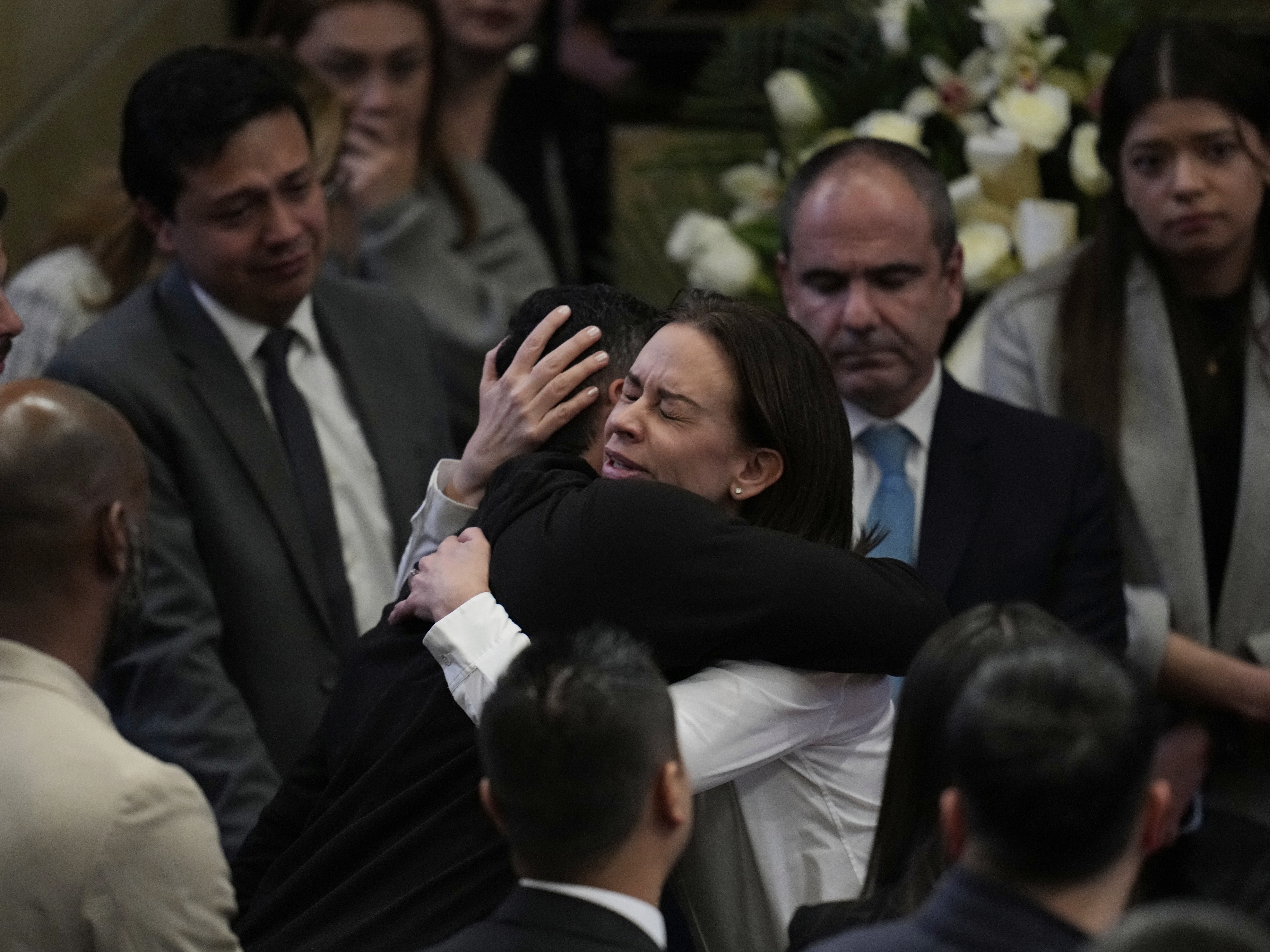 caption: Claudia Tarazona, the wife of opposition Sen. and presidential hopeful Miguel Uribe, who died from wounds suffered when he was shot during a political rally, attends a ceremony honoring her husband, at Congress in Bogota, Colombia on Monday.