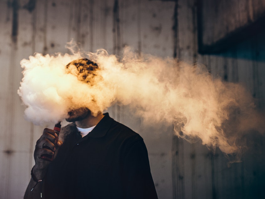 caption: "There's a certain notion that e-cigarettes are harmless," says Dr. Paul Ndunda, an assistant professor at the School of Medicine at the University of Kansas in Wichita. "But ... while they're less harmful than normal cigarettes, their use still comes with risks."