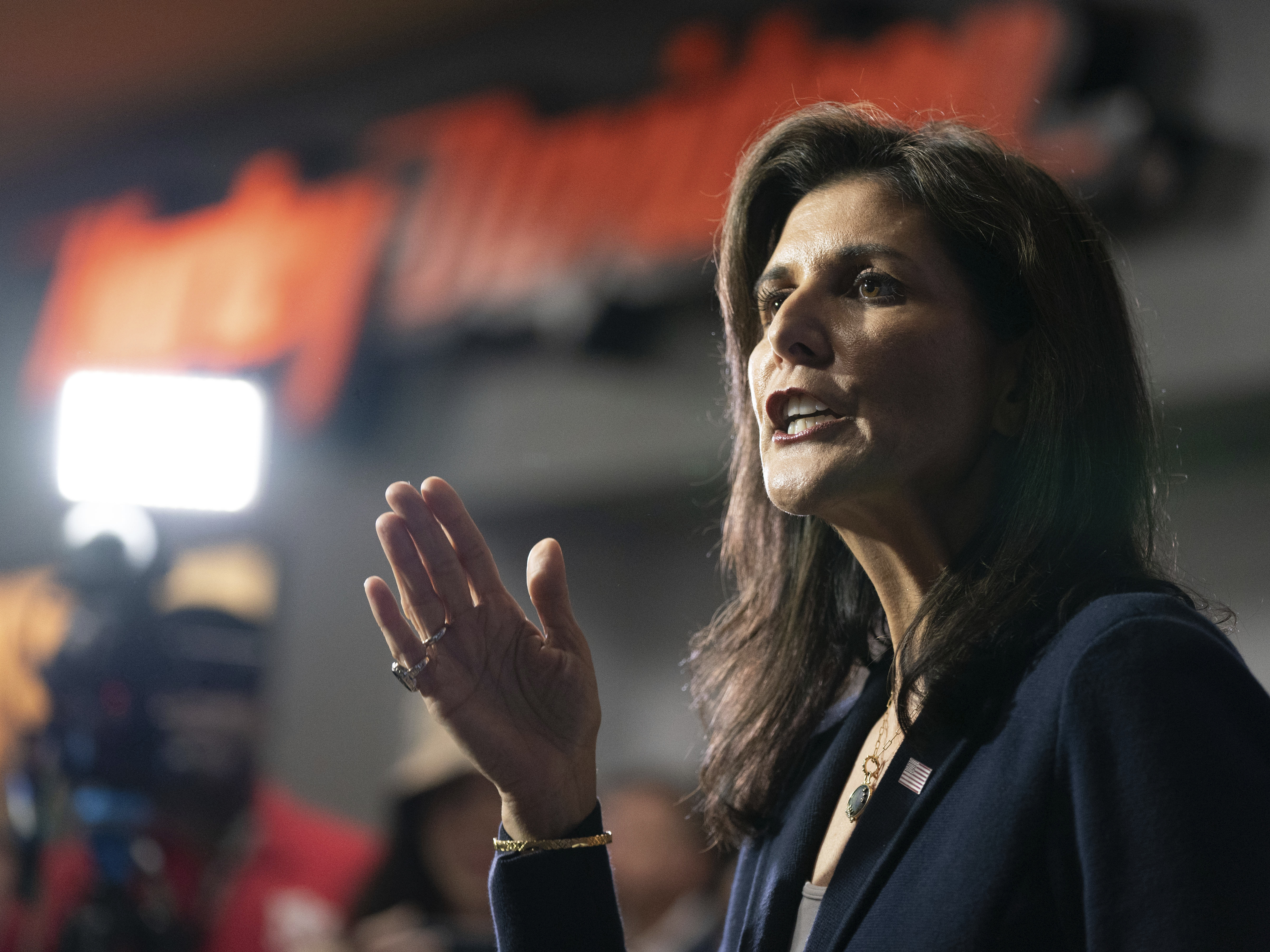 caption: Republican presidential candidate former UN Ambassador Nikki Haley speaks to members of the media during a campaign event at Thunder Tower Harley Davidson Monday, Feb. 12 in Elgin, S.C. On the campaign trail, Haley has stepped up attacks against Vice President Kamala Harris, drawing parallels between herself and the vice president.