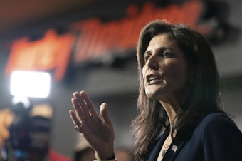 caption: Republican presidential candidate former UN Ambassador Nikki Haley speaks to members of the media during a campaign event at Thunder Tower Harley Davidson Monday, Feb. 12 in Elgin, S.C. On the campaign trail, Haley has stepped up attacks against Vice President Kamala Harris, drawing parallels between herself and the vice president.
