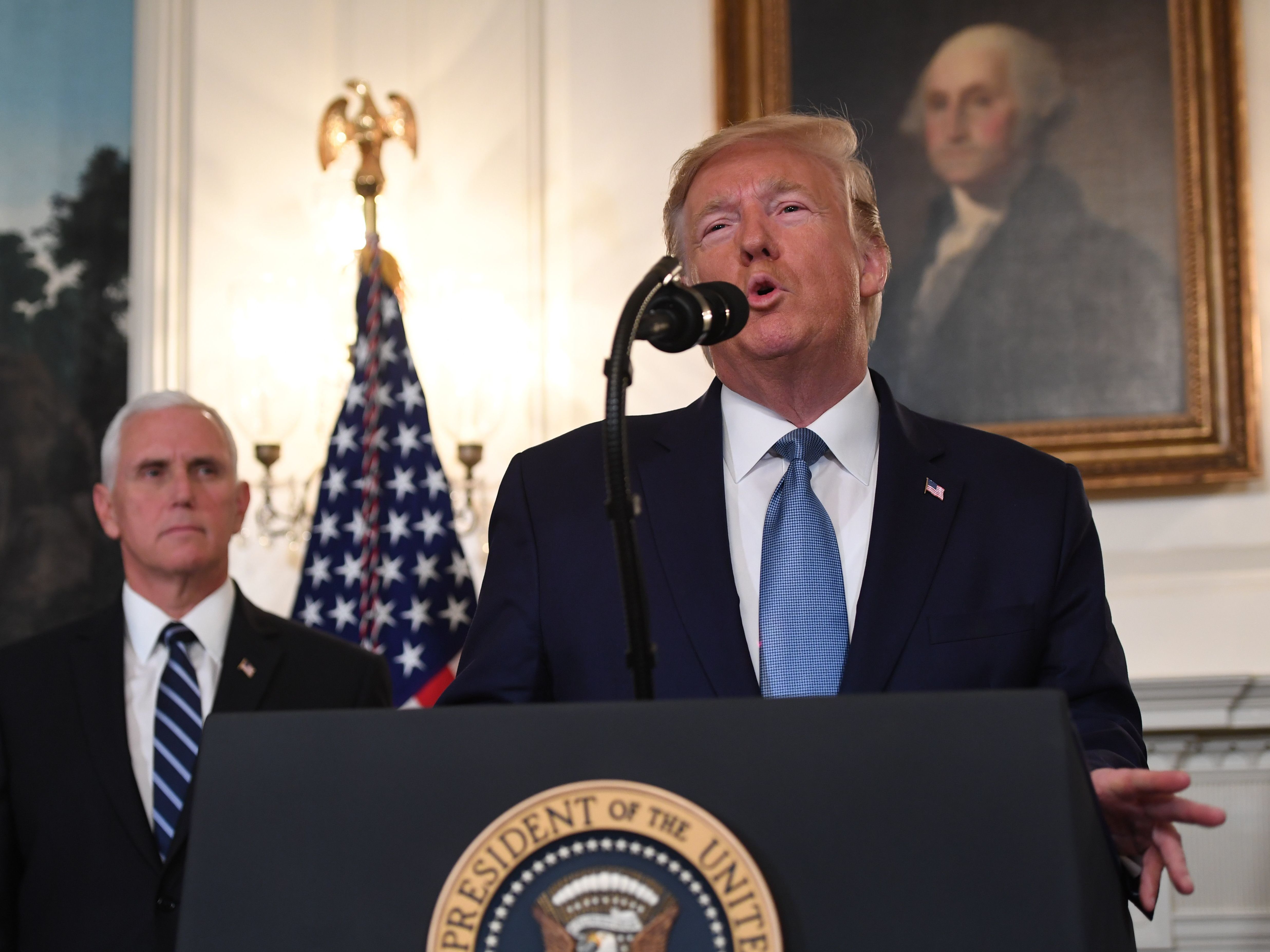 caption: President Trump speaks about Syria in the Diplomatic Reception Room at the White House on Wednesday with Vice President Pence listens.