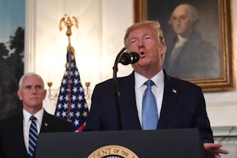 caption: President Trump speaks about Syria in the Diplomatic Reception Room at the White House on Wednesday with Vice President Pence listens.