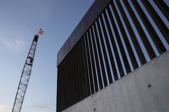 caption: A new section of the border wall is seen in November 2019 south of Donna, Texas. Trump's 576-mile border wall is expected to cost nearly $20 million per mile, which is more expensive than any other wall under construction in the world.