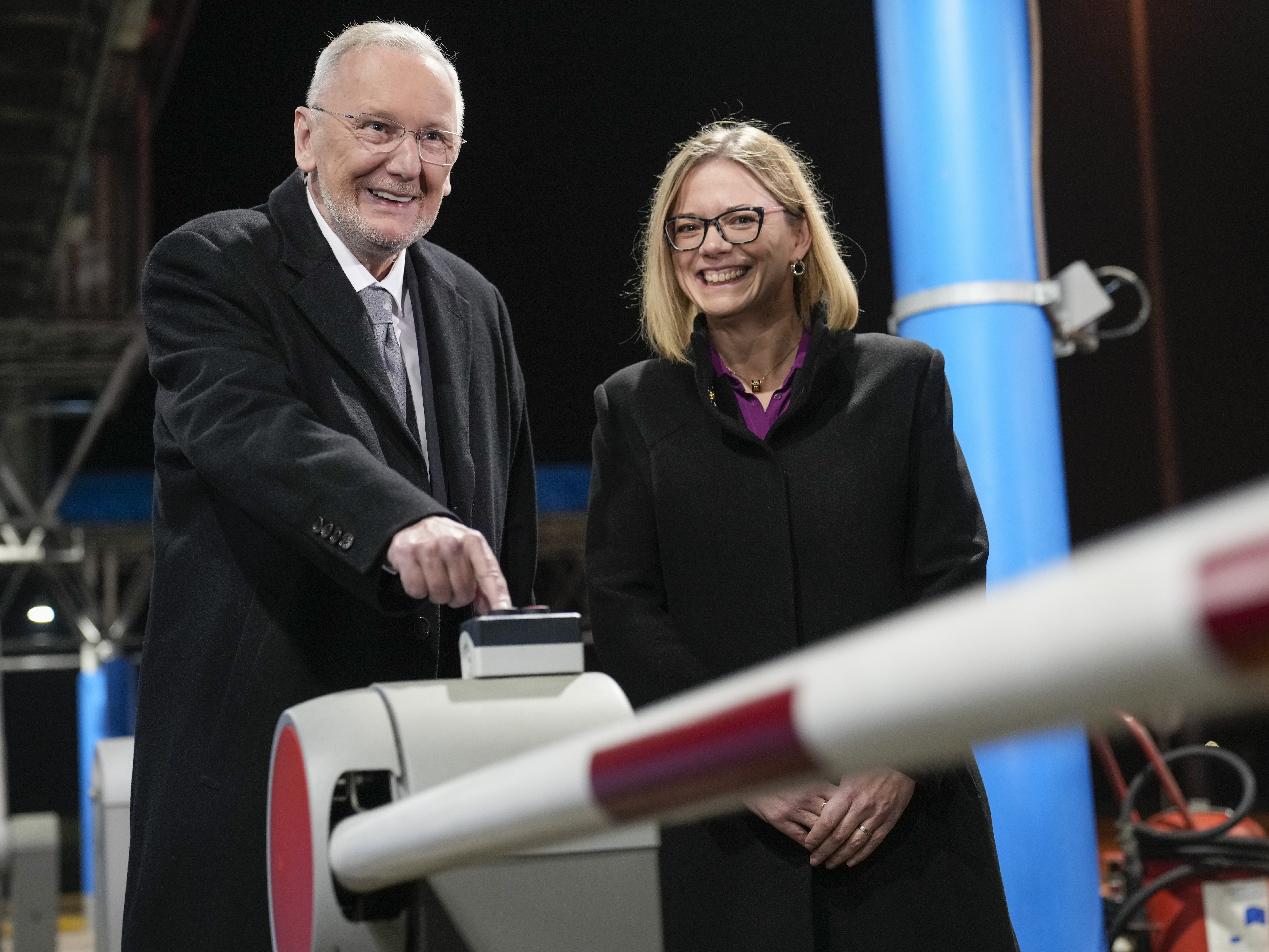 caption: Croatia's Minister of Interior Davor Bozinovic, left, pushes a button to lift the barrier at the Bregana border crossing between Croatia and Slovenia, accompnanied by Slovenian counterpart Sanja Ajanovic Hovnik, early on Sunday.