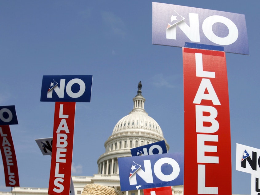 caption: People with the group No Labels hold signs during a rally on Capitol Hill in 2013. The No Labels group says it won't field a presidential candidate in November after strategists for the bipartisan organization were unable to attract a candidate willing to seize on the widespread dissatisfaction with President Joe Biden and Donald Trump.