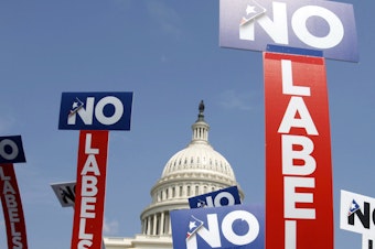 caption: People with the group No Labels hold signs during a rally on Capitol Hill in 2013. The No Labels group says it won't field a presidential candidate in November after strategists for the bipartisan organization were unable to attract a candidate willing to seize on the widespread dissatisfaction with President Joe Biden and Donald Trump.