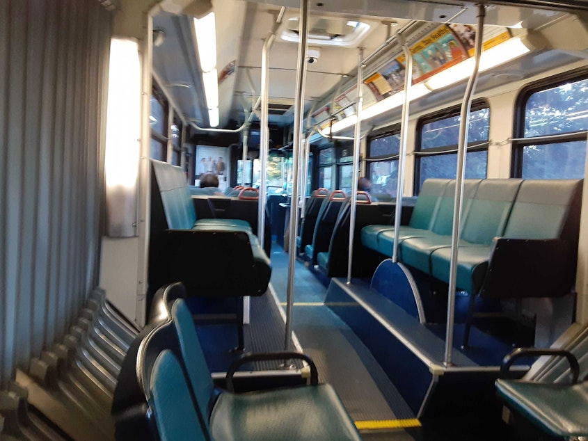 caption: A King County Metro bus in Seattle on Monday, March 16, 2020. The first weekday after Gov. Jay Inslee ordered no public gatherings more than 50 people, and also shut down restaurants and bars statewide in response to the COVID-19 outbreak. 