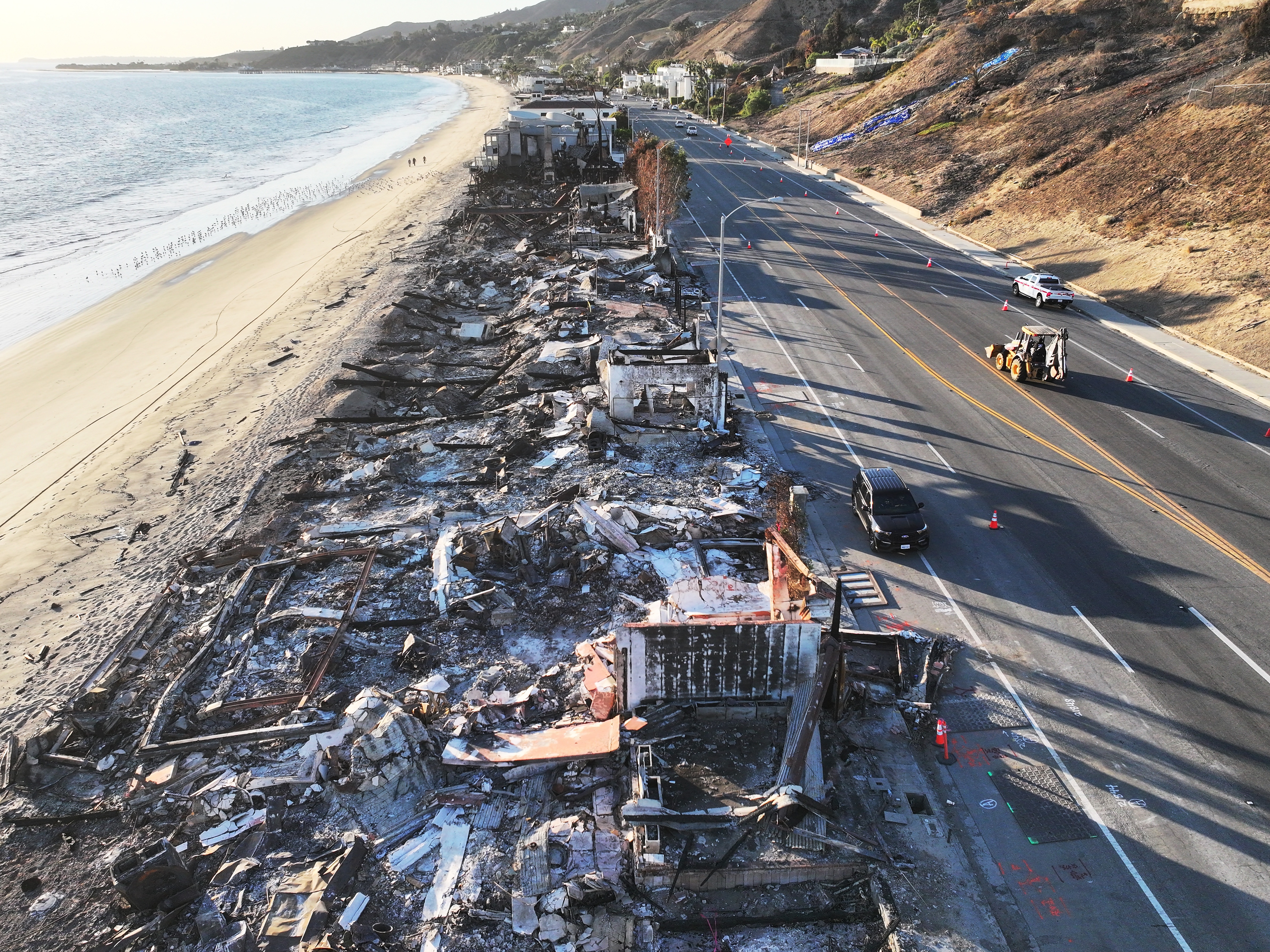 caption: An aerial view of beachfront homes that burned in the Palisades Fire in Malibu, Calif. on Jan. 15, 2025. Pro-Kremlin social media accounts have spread baseless claims that Ukrainian military officials owned mansions that were destroyed in the fires that swept the Los Angeles region.