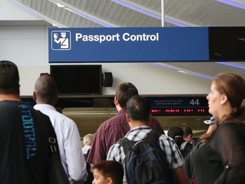 caption: International travelers wait to have their passports checked at O'Hare International Airport in Chicago, 2014. The new agreement to allow visa-free U.S. entry to Israeli tourists and businesspeople requires Israel to end bans and restrictions on Palestinian Americans and other Arab Americans traveling to Israel.