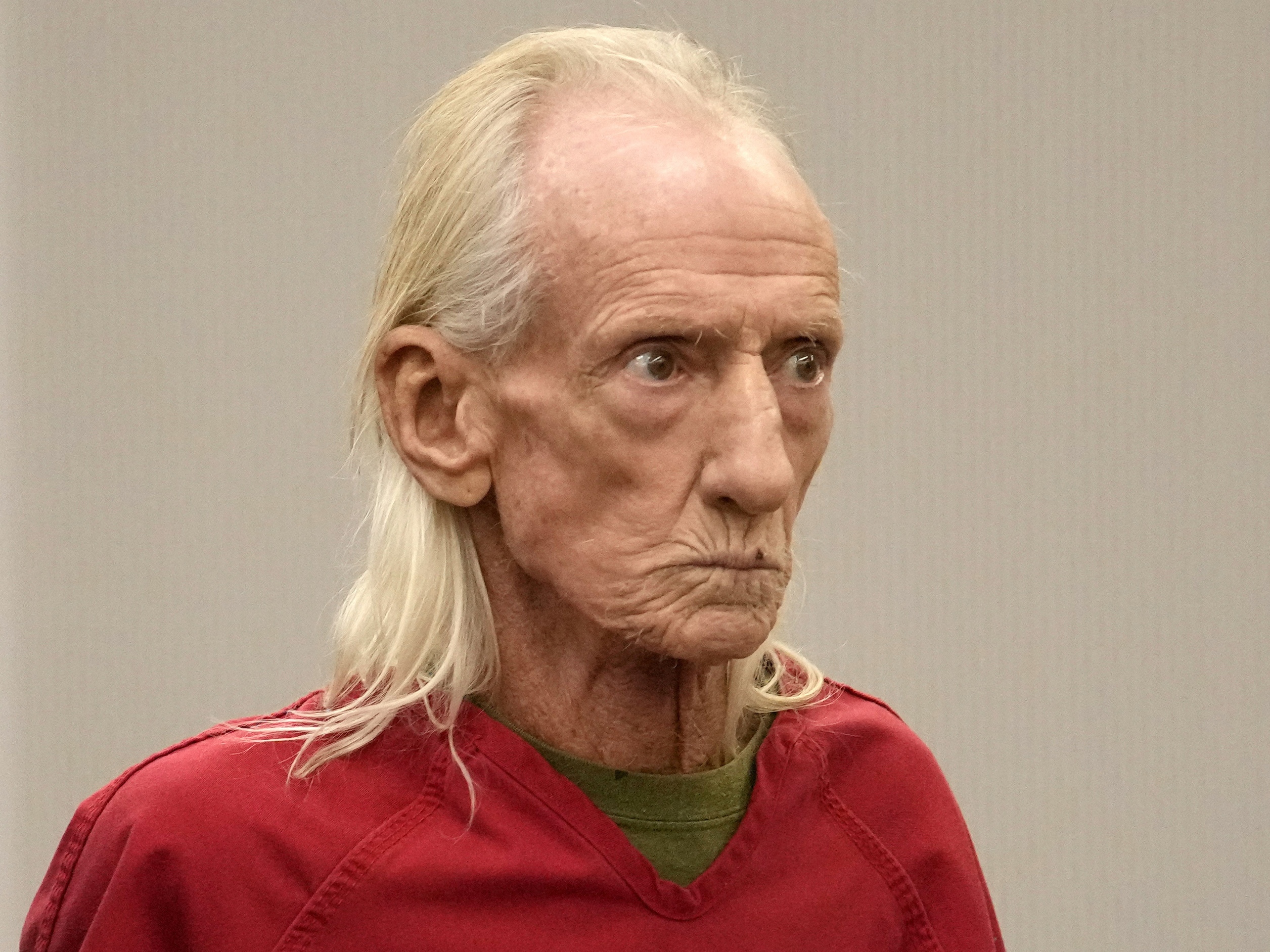 caption: Joseph Czuba is shown standing before Circuit Judge Dave Carlson for his arraignment at the Will County courthouse, Oct. 30, 2023, in Joliet, Ill.