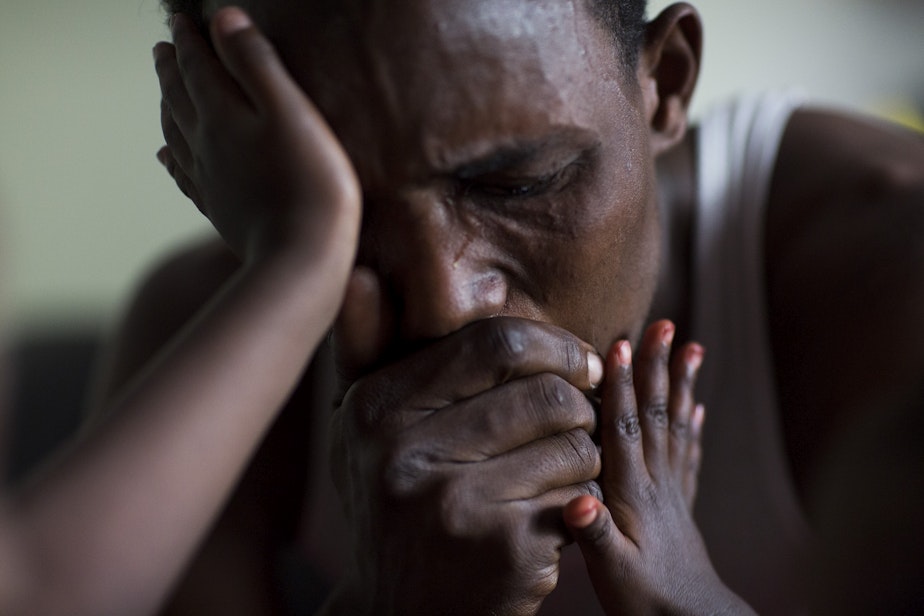 caption: Osman Mohamed, a refugee from Somalia who ended up in a camp in Kenya, cries upon hearing that his father has been having medical problems. 