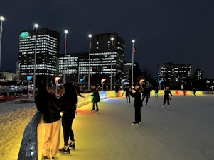 caption: Ice skaters in front of Ottawa City Hall in Ontario on Dec. 12, 2023.