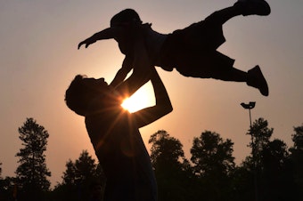 caption: A father plays with his son at a park in Amritsar, India, on Father's Day in June 2016.