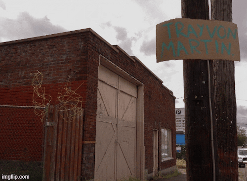 caption: A series of hand-painted cardboard signs bearing the names of Black men killed by police and vigilantes appear on telephone poles along Fremont Avenue. The signs appeared within a week of the first protests in downtown Seattle, and similar signs have continued to appear across the city. Other event flyers and advertisements on these poles were removed months ago.