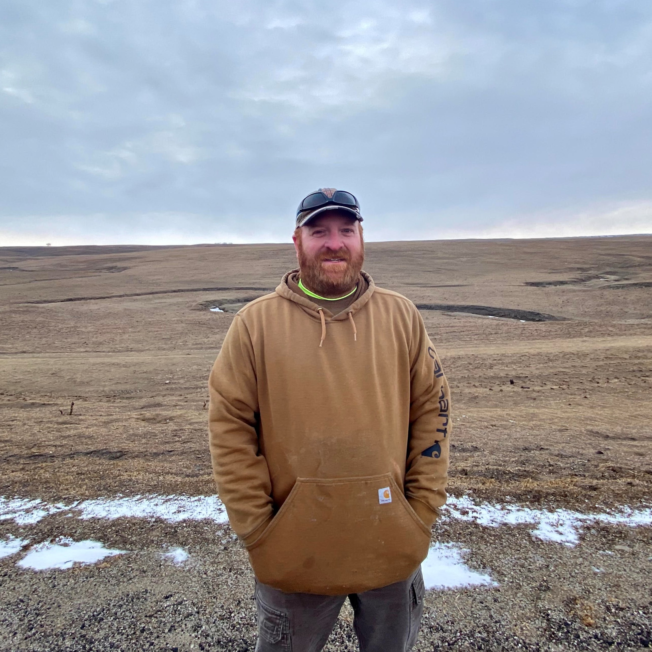caption: Quentin Maupin stands on the spot where his firetruck was overcome by a 60-80 foot wall of flame in the Dec.15 Kansas wildfires.