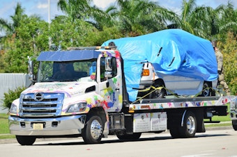 caption: A van belonging to Cesar Sayoc covered in blue tarp was towed by FBI investigators to FBI Miramar Headquarters. The suspect was arrested in connection to the string of pipe bombs mailed to prominent Democrats across the country.