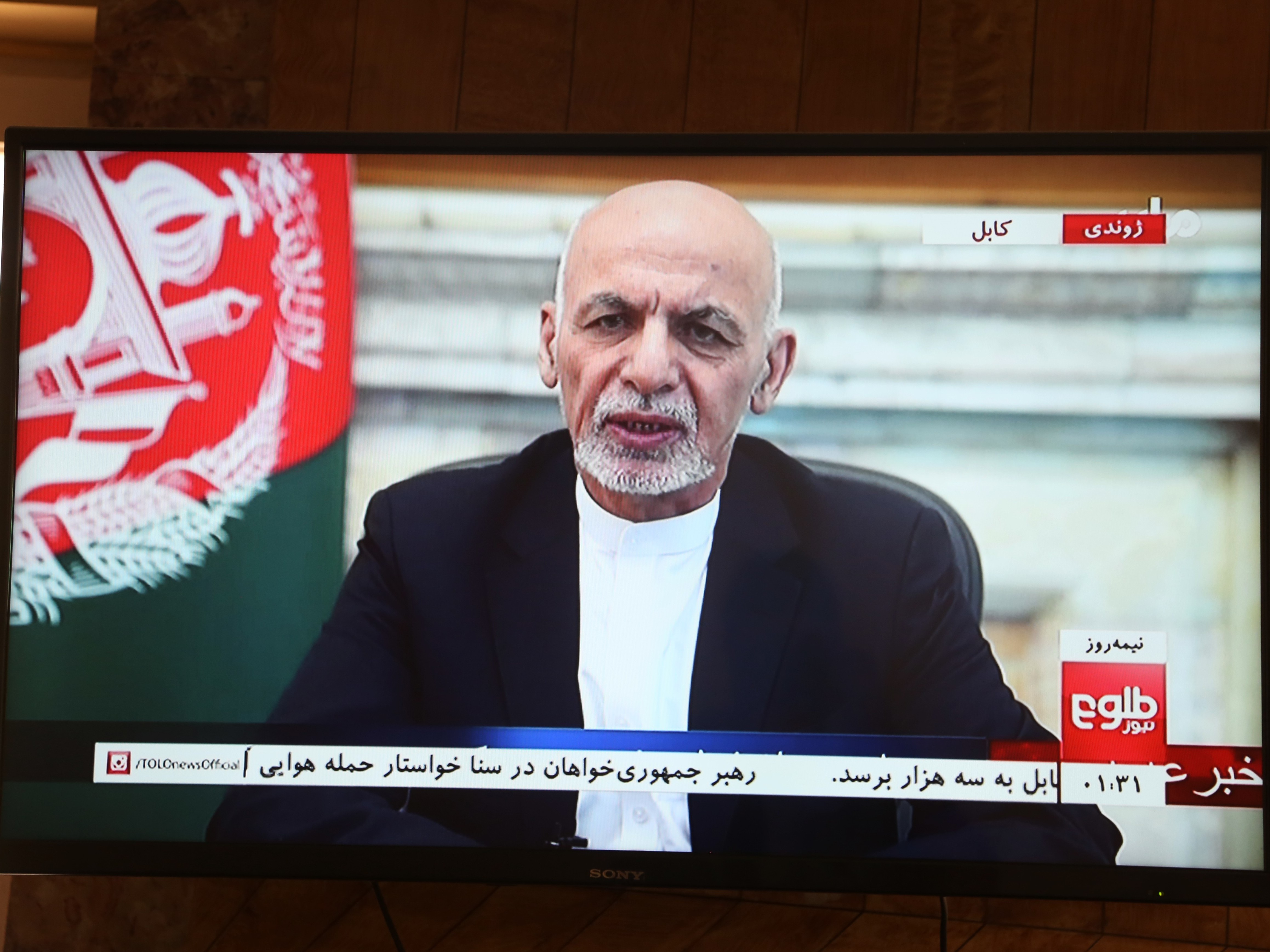 caption: Mohammad Ashraf Ghani, speaks in a televised address in Kabul, capital of Afghanistan, on August 14, a day before the country's capital fell to the Taliban.