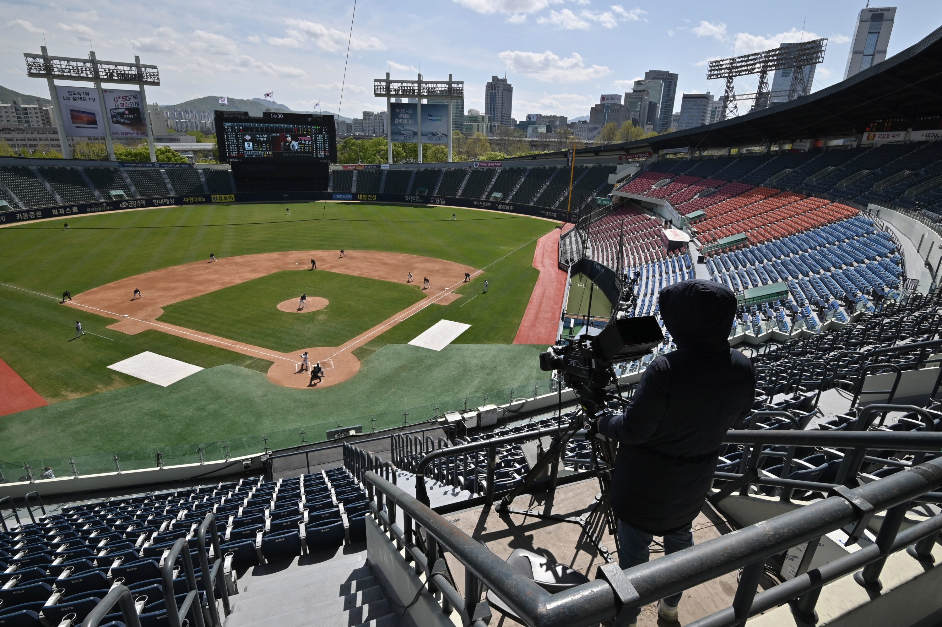 caption: Professional sport returned to South Korea on April 21 as coronavirus restrictions ease, with the first pitch thrown in a baseball preseason derby in front of empty stands. (Jung Yeon-je /AFP via Getty Images)