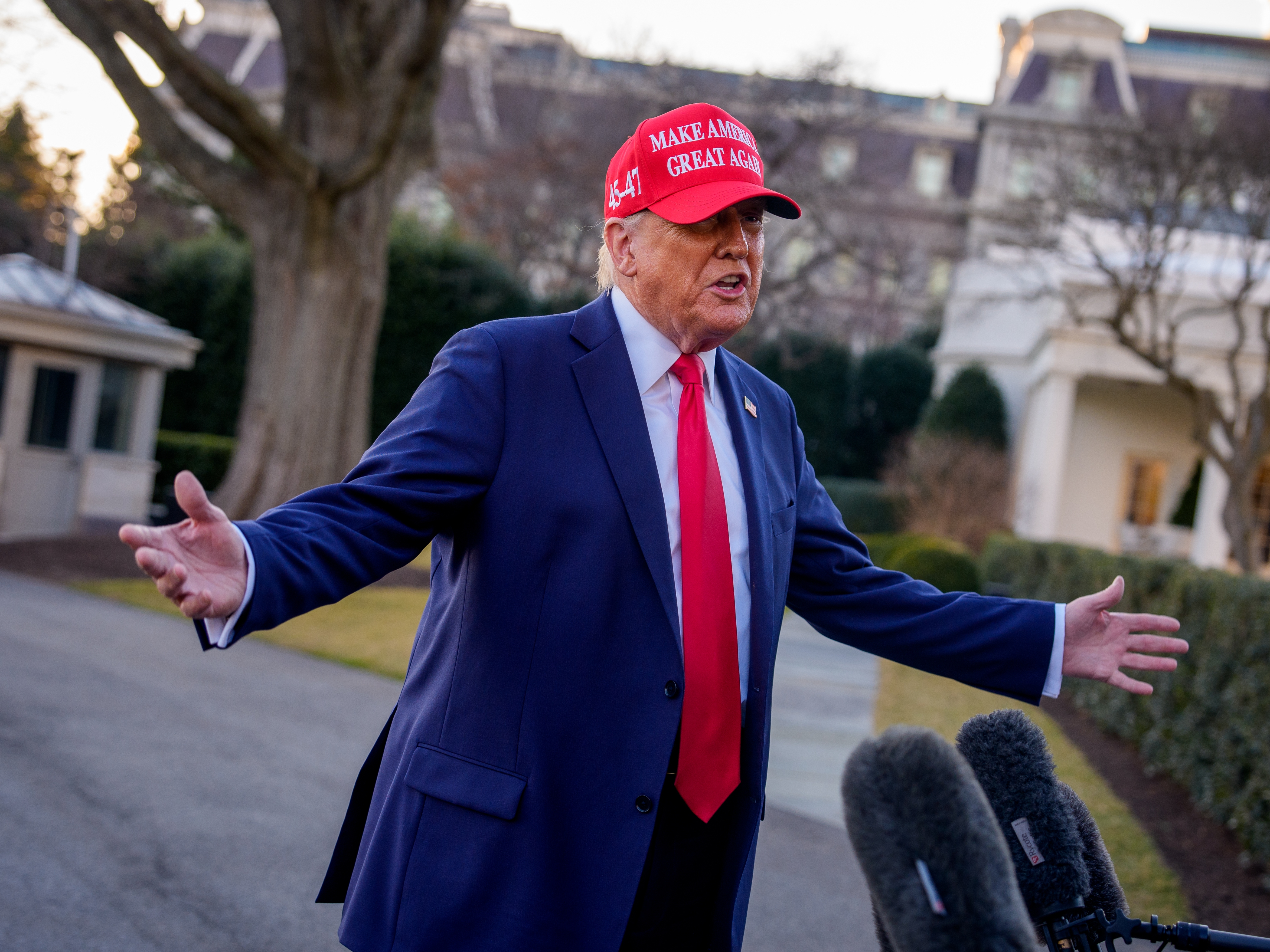 caption: President Trump speaks to members of the media before boarding Marine One on the South Lawn of the White House on Feb. 28.