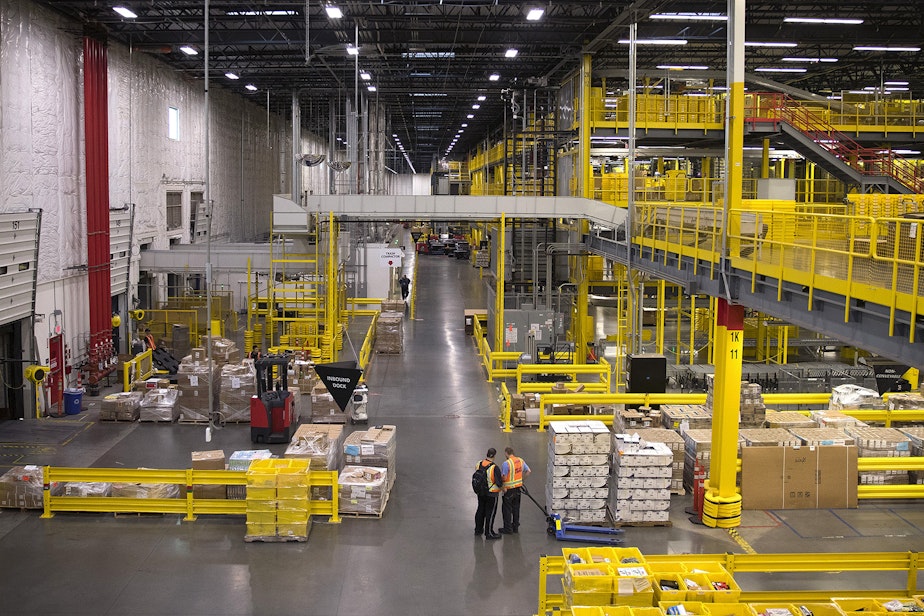caption: The interior of an Amazon fulfillment center is shown on Friday, November 3, 2017, in Kent. 