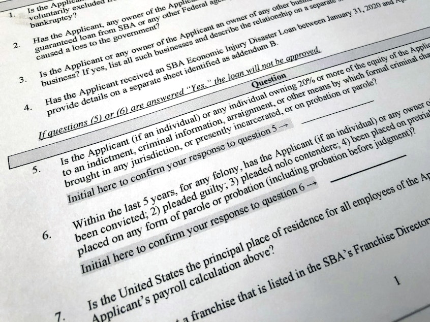 caption: The Justice Department has accused 57 people of defrauding the Paycheck Protection Program. A portion of the program's application is shown here.