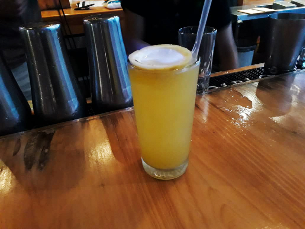 caption: A cocuy drink made with pepper sauce and fruit juice on a local bar in Barquisimeto.