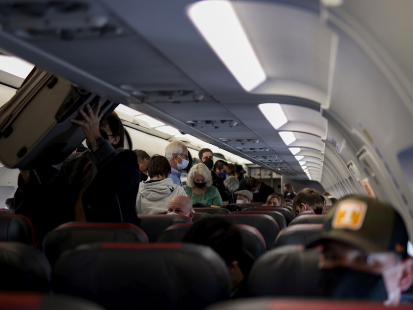 caption: Passengers deplane from an airplane after landing at the Albuquerque International Sunport on Nov. 24, 2021 in Albuquerque, New Mexico.