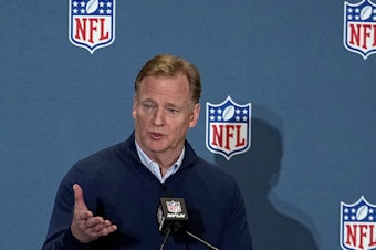 caption: NFL Commissioner Roger Goodell speaks to the media on March 28 in Phoenix. The attorneys general of New York and California announced Thursday that they are investigating allegations of workplace discrimination by the pro football league.