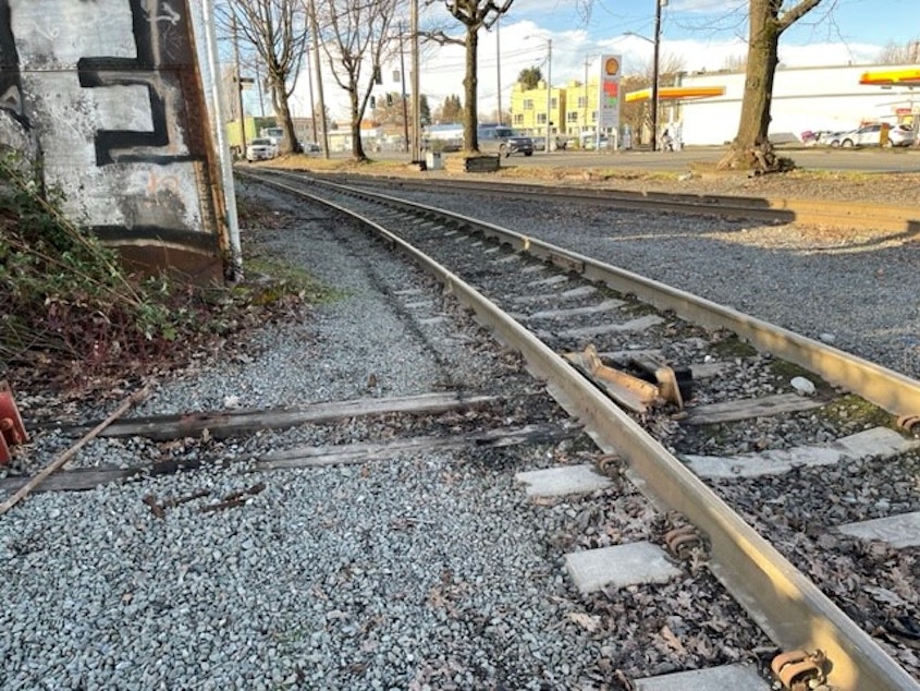 caption: A derailer device sits inside railroad tracks in Seattle.