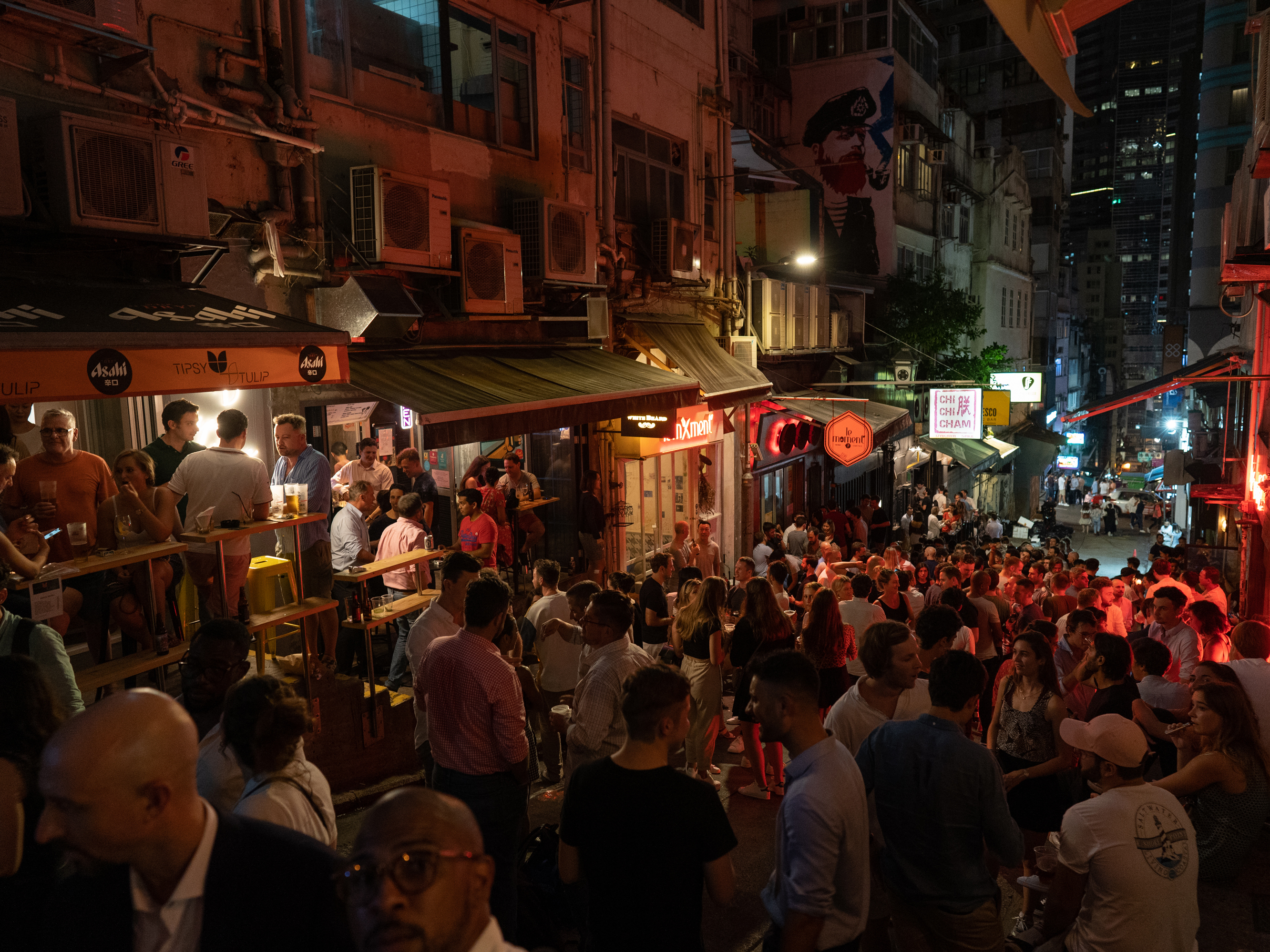 caption: After shuttering bar districts early in the pandemic, Hong Kong reopened its them in May(above, the Soho area). Some have been linked to new clusters of cases; the kind of prolonged, face-to-face contact that takes place in bars is widely recognized as the ideal condition for the novel coronavirus to spread.