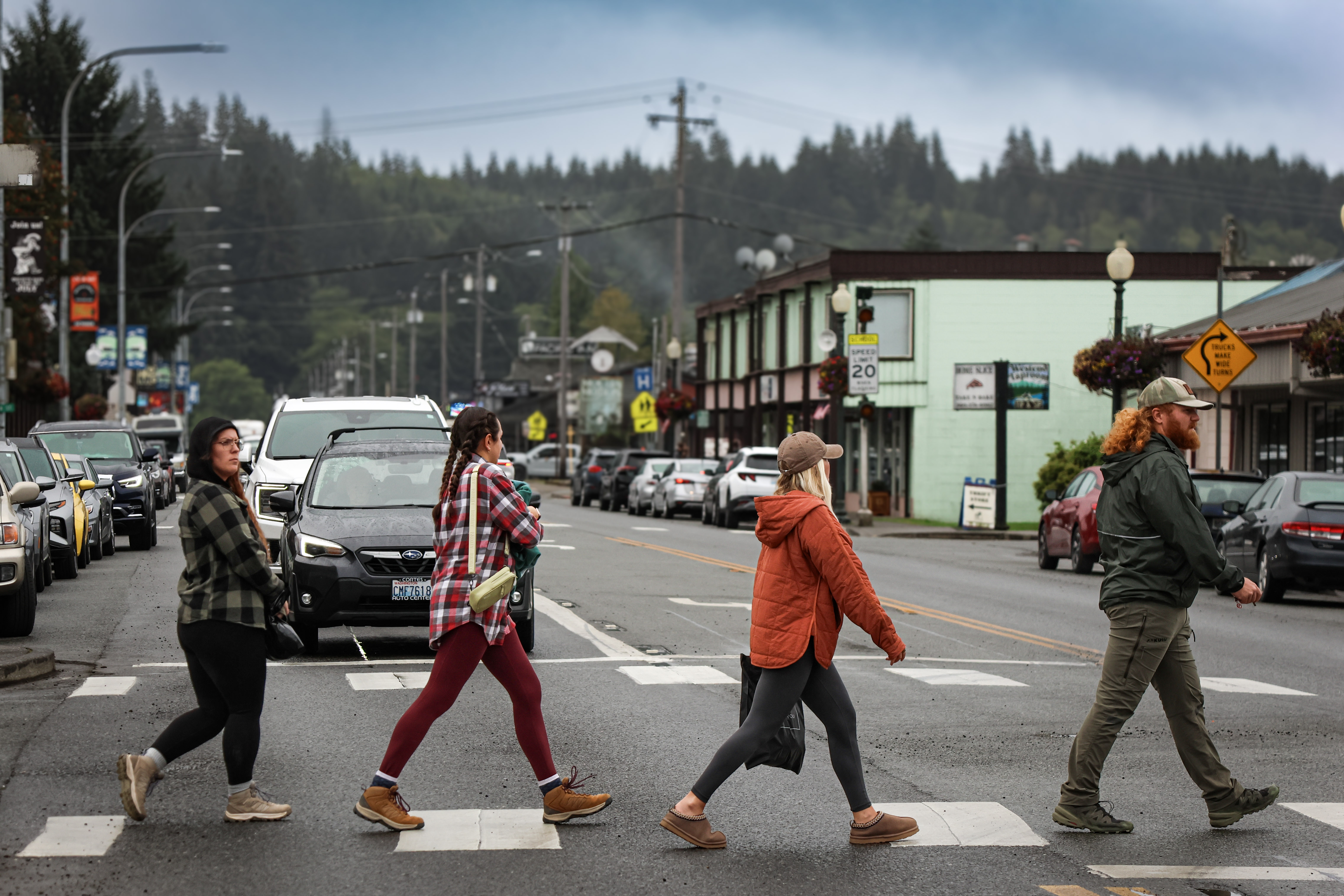 caption: People walk through downtown Forks, Washington, during a celebration of the "Twilight" series' 20th anniversary. 