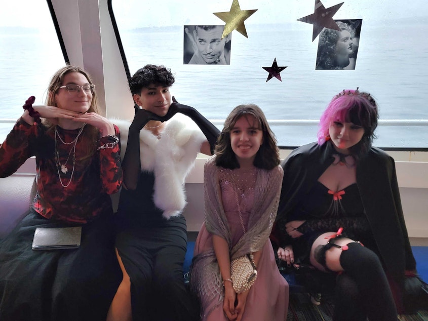 caption: Micky Randolph, Antonio Nevarez, Ava Cook, and Lucia Lavador pose for a photo at prom on the Argosy Goodtime III in Seattle on June 4, 2022. These are the people heard in the "my friends are looking at outfit inspiration" part of the story. The prom was "Hollywood Glamour" theme. Photo courtesy of Antonio Nevarez.