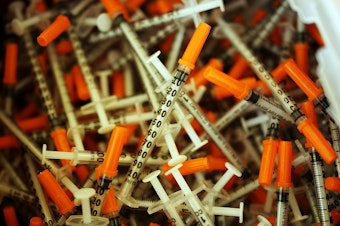 caption: Used syringes are discarded at a needle exchange clinic in Vermont in 2014. Americans' odds of dying from an opioid overdose have risen in recent years.