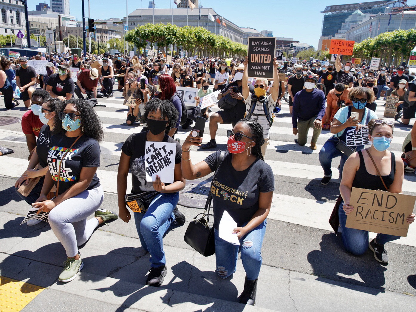 Hundreds of protesters rally outside City Hall on Tuesday, June 9, 2020, in San Francisco, California. Protestors are seen holding signs and kneeling. (Santiago Mejia/The San Francisco Chronicle via Getty Images)