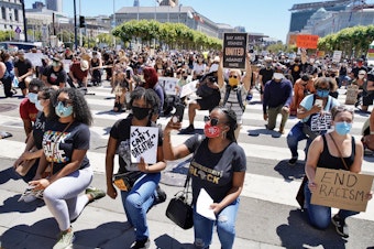 Hundreds of protesters rally outside City Hall on Tuesday, June 9, 2020, in San Francisco, California. Protestors are seen holding signs and kneeling. (Santiago Mejia/The San Francisco Chronicle via Getty Images)